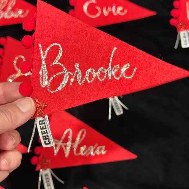 red pennant flag with bedazzled calligraphy name